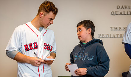 The temperatures outside were dipping near zero, but all was warm inside the Jimmy Fund Clinic when young Red Sox players visited patients and families.